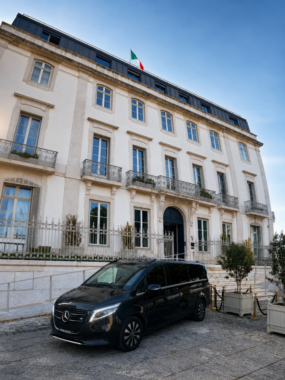 Mercedes Classe V estacionado diante de fachada palaciana ao fim do dia